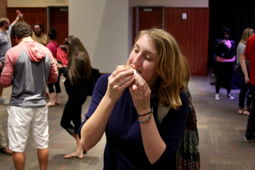 A student bites down on a Krispy Cream donut.