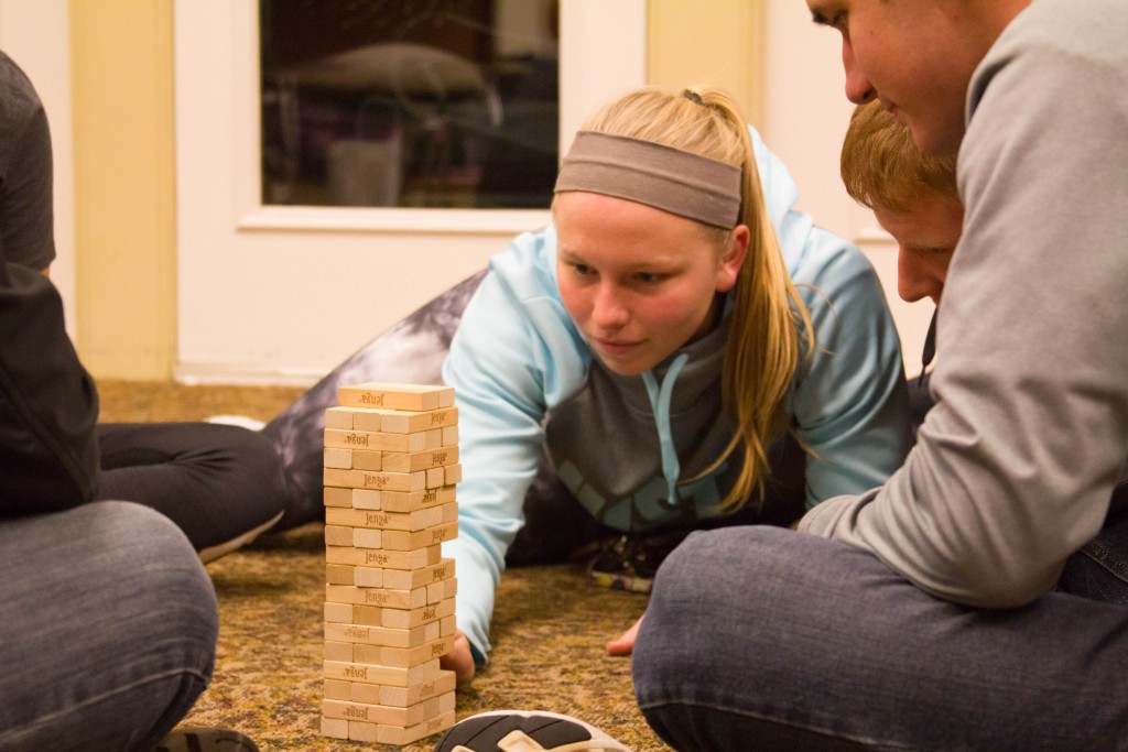 Student in deep concentration as she plays Jenga.