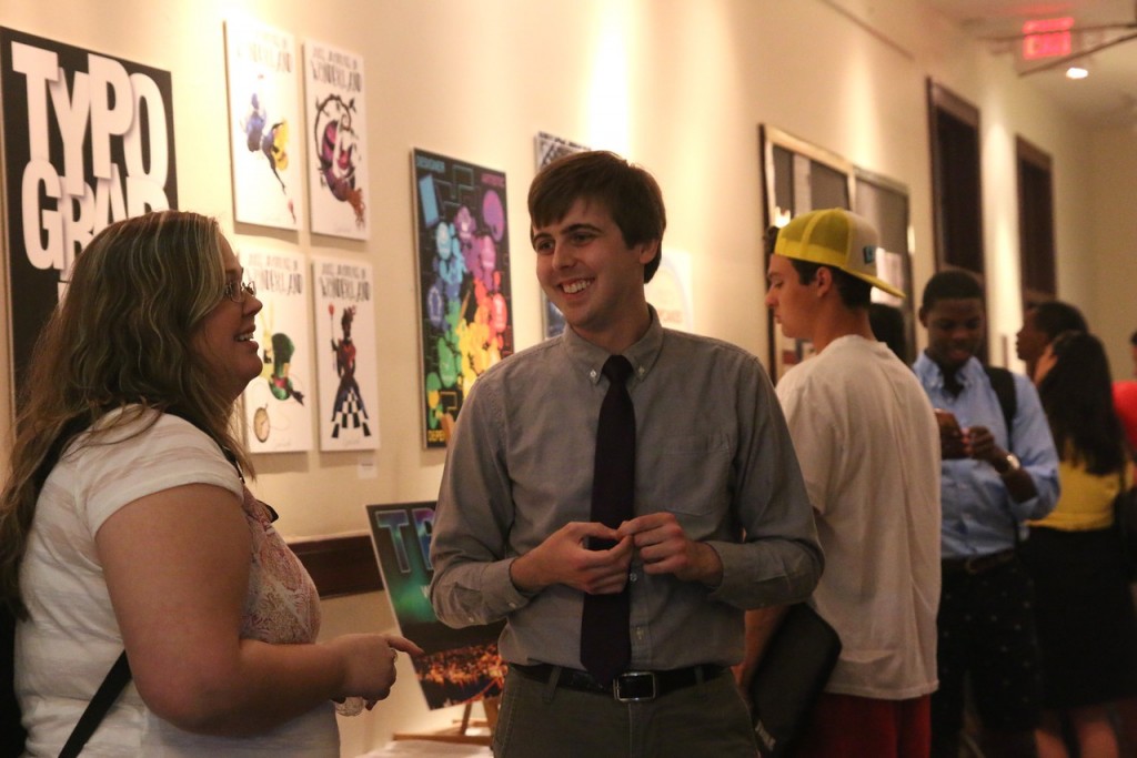 Graphic design major, Taylor Alexander, shares his work with family and friends.