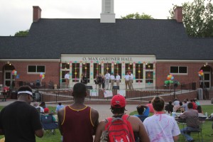 Students watch as new acapella group, Note This, performs on the patio. Photo by Isaiah Johnson